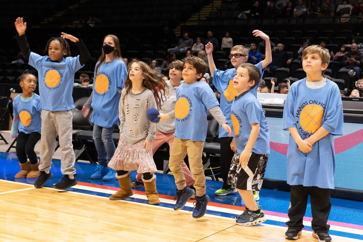 Hands On Hoops kids celebrating on an NBA court