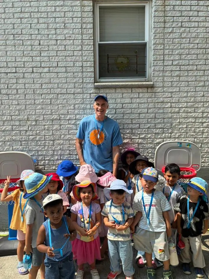 Coach Mike with a full group of young kids after an outdoor class